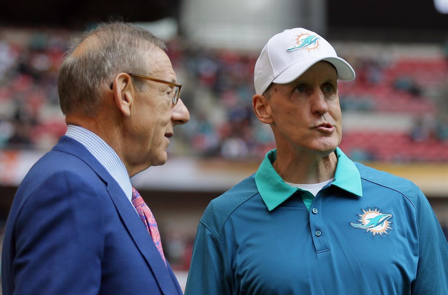 FILE - In this Oct. 4, 2015, file photo, Miami Dolphins owner Stephen Ross, left, and Miami Dolphins head coach Joe Philbin chat during warm-up before the NFL football game between the New York Jets and the Miami Dolphins at Wembley stadium in London. Philbin was fired Monday, Oct. 5, 2015, four games into his fourth season as coach of the Dolphins, and one day after a flop on an international stage that apparently sealed his fate.(AP Photo/Tim Ireland, File) ORG XMIT: NY154