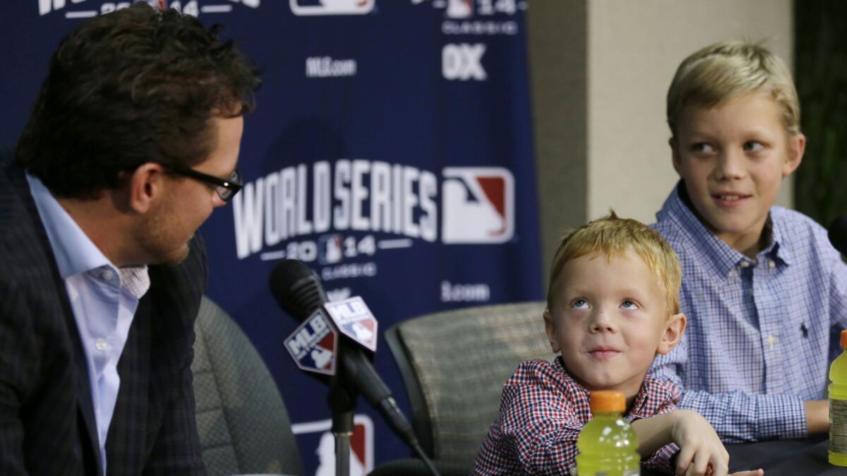 San Francisco Giants pitcher Jake Peavy, left, watches as his son Judson, center, and Wyatt, right, respond to a question about who their favorite player is during a news conference in Kansas City on Monday.