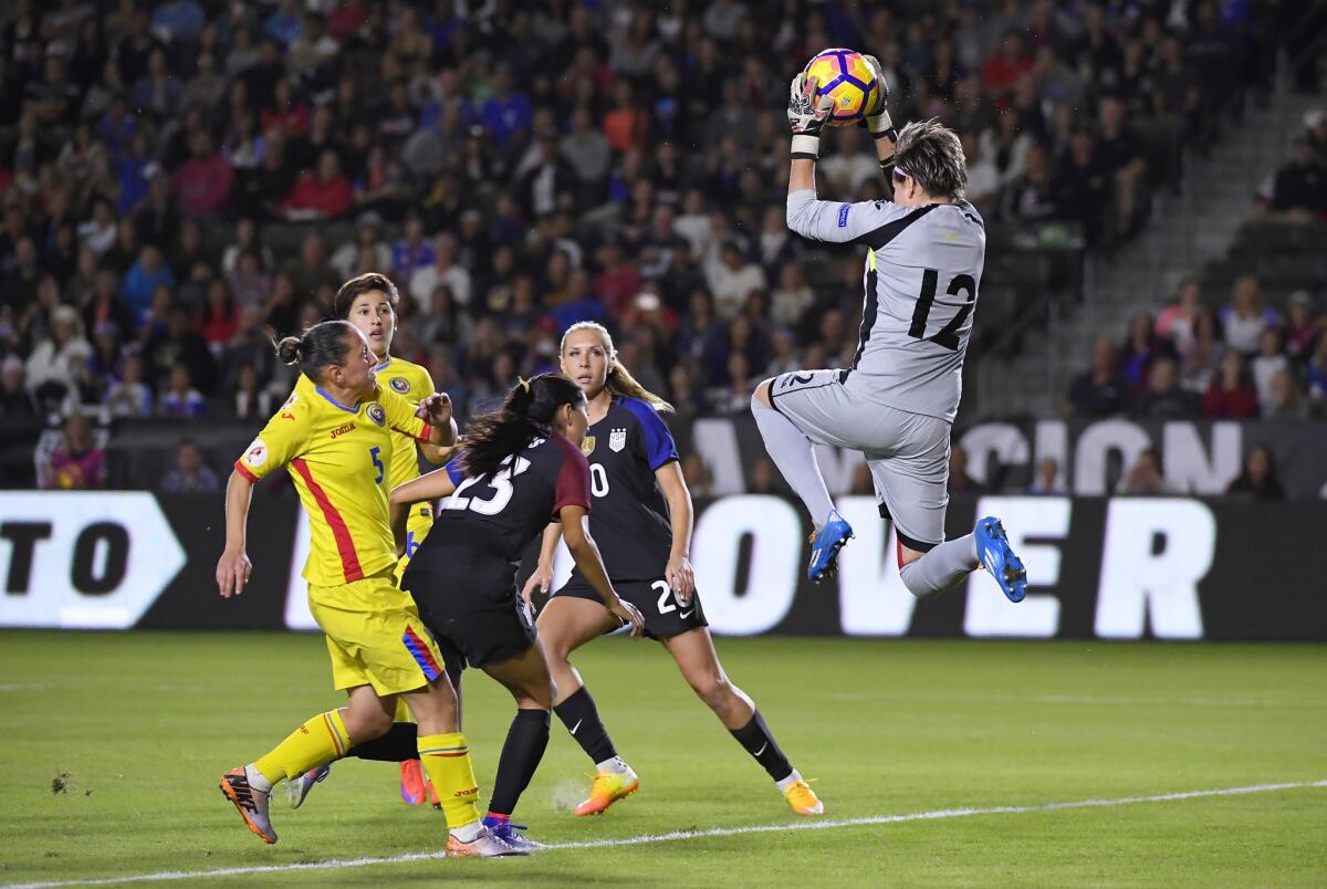 Romania goalkeeper Roxana Oprea, right, stops a shot during the first half of an exhibition soccer match against the United States, Sunday, Nov. 13, 2016, in Carson, Calif. (AP Photo/Mark J. Terrill)