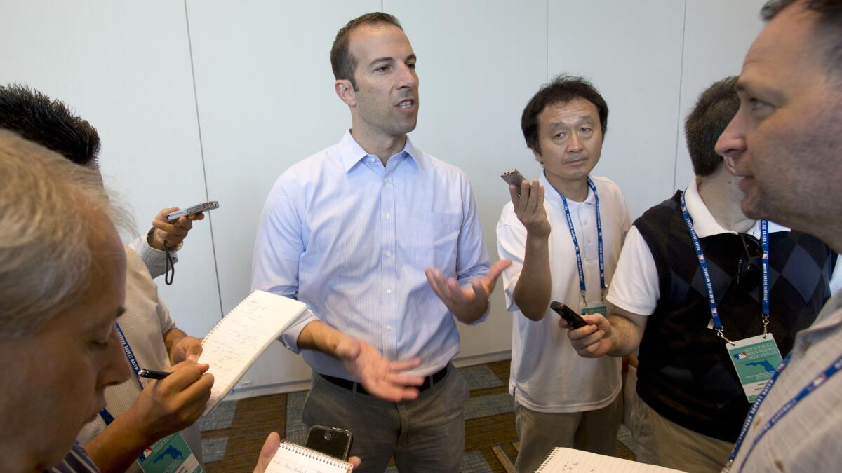 Angels General Manager Billy Eppler, center, speaks to reporters Wednesday in Boca Raton, Fla.