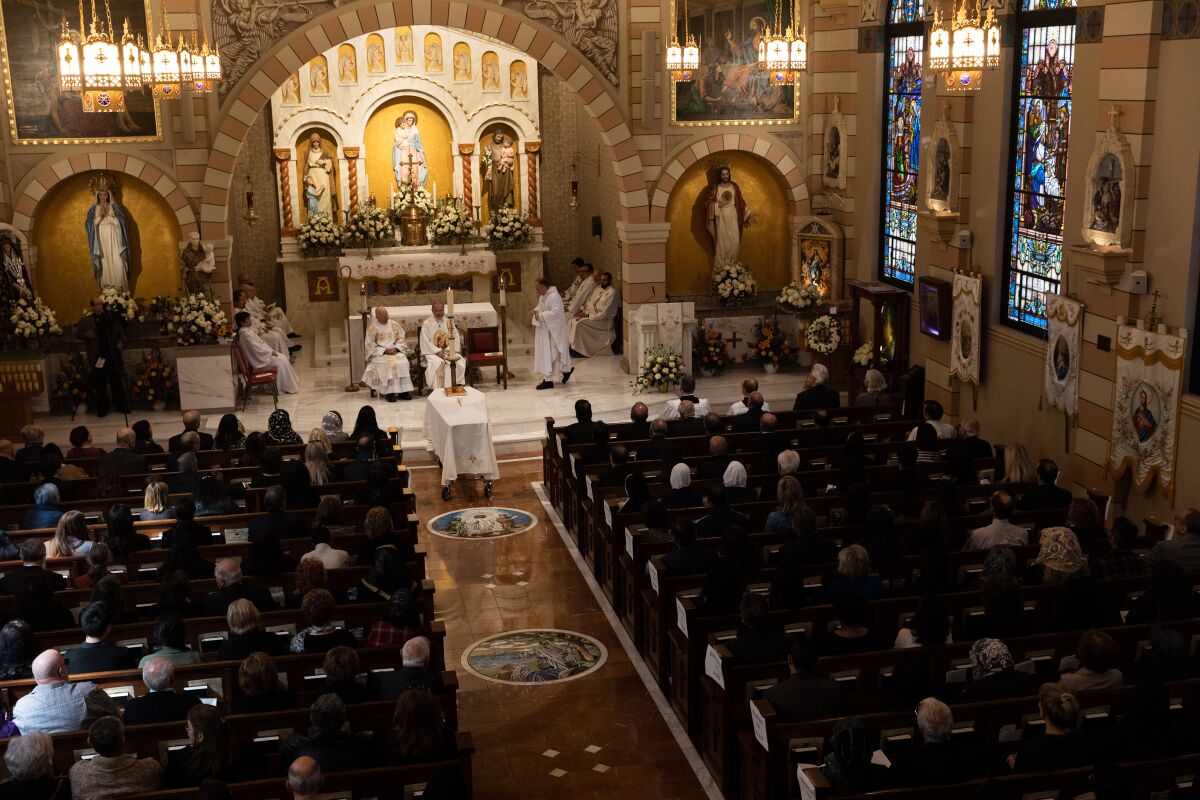 Parishioners attend a funeral mass for Father Louis Solcia at Our Lady of the Rosary Catholic Church