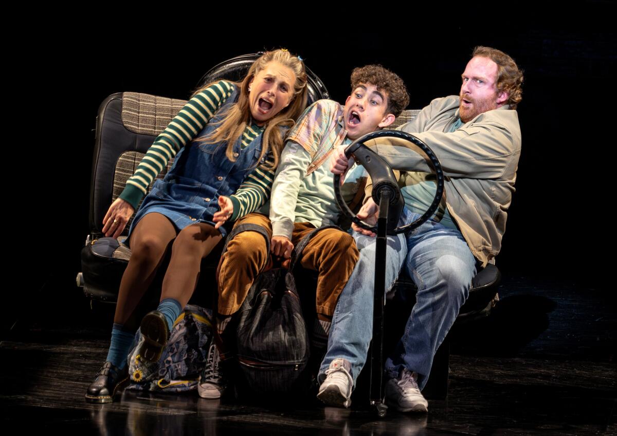 Three actors pretend to corner sharply in a "car" onstage