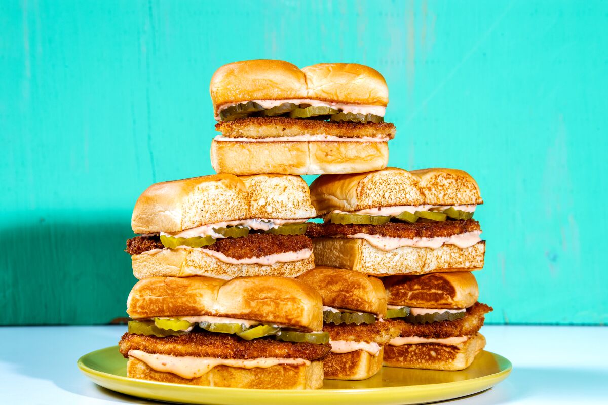 A stack of fried chicken sandwiches on a platter