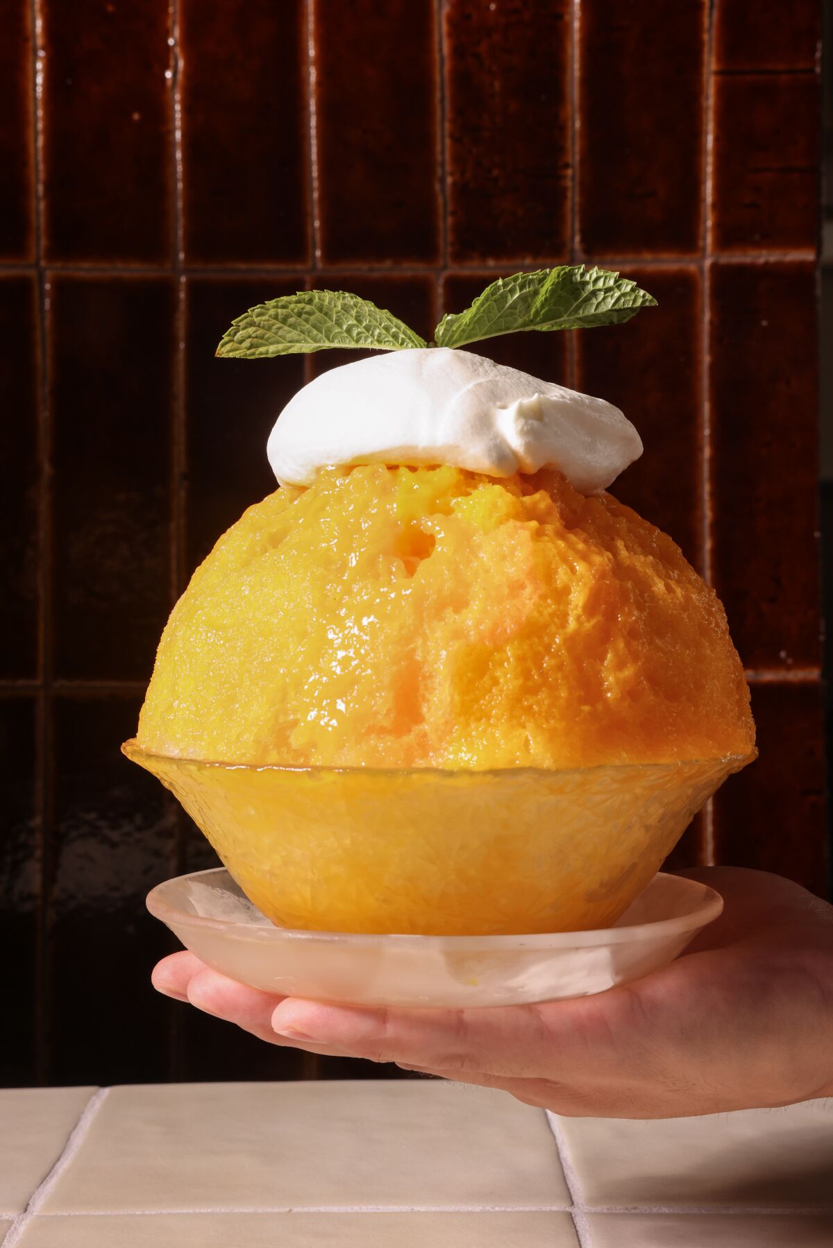 A mango-flavored shaved ice in a bowl