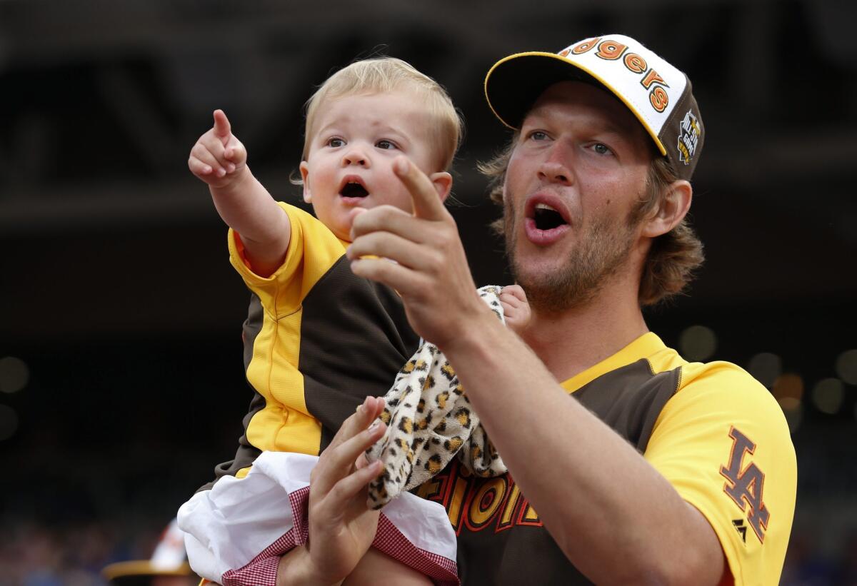 Clayton Kershaw and daughter Cali Ann watch the Home Run Derby on Monday.