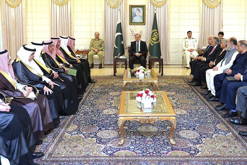 In this photo released by Prime Minister Office, visiting Saudi Foreign Minister Prince Faisal bin Farhan, seventh left, meets with Pakistan's Prime Minister Shehbaz Sharif, center, in Islamabad, Pakistan, Tuesday, April 16, 2024. Saudi Arabia's foreign minister led a high-level delegation on a two-day visit to Pakistan, which is seeking help in overcoming one of its worst economic crises. (Prime Minister Office via AP)