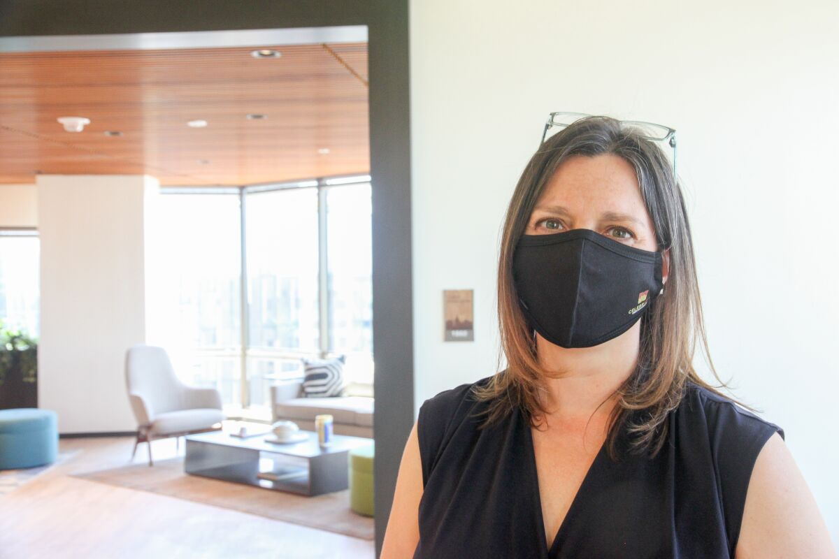Kirsten Marriner, shown wearing a black COVID mask