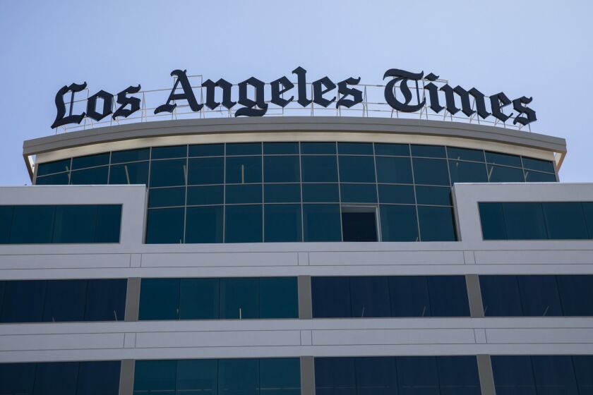EL SEGUNDO,CA --WEDNESDAY, JUNE 27, 2018--Workers put the new sign on top of the new Los Angeles Times headquarters in June 27, 2018. The paper, recently bought by L.A. billionaire, Dr. Patrick Soon-Shiong, is leaving its downtown L.A. headquarters for the El Segundo building, owned by Soon-Shiong, after previous owner, Chicago-based Tribune Media Co., sold the downtown property to Canadian developer Onni Group in 2016. (Jay L. Clendenin / Los Angeles Times)