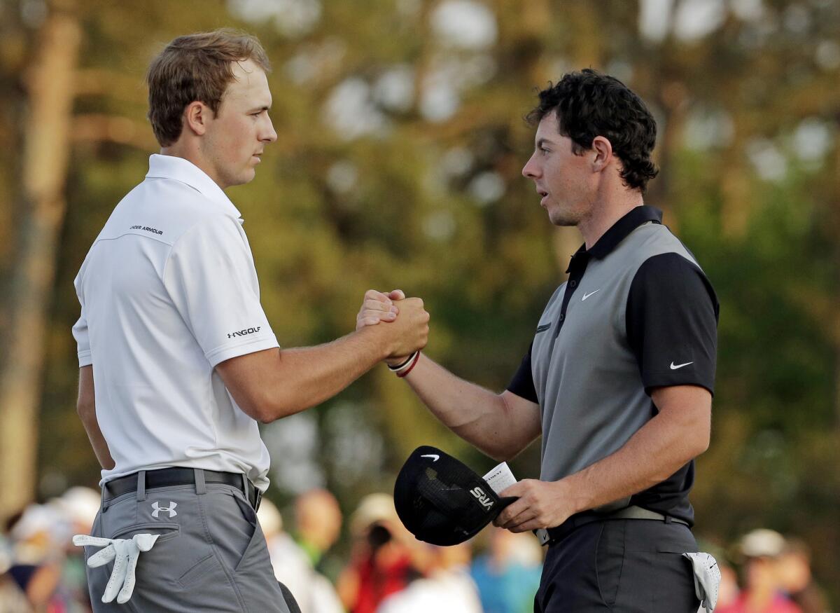 Jordan Spieth and Rory McIlroy shake hands after the second round of the Masters at Augusta National on April 11, 2014.