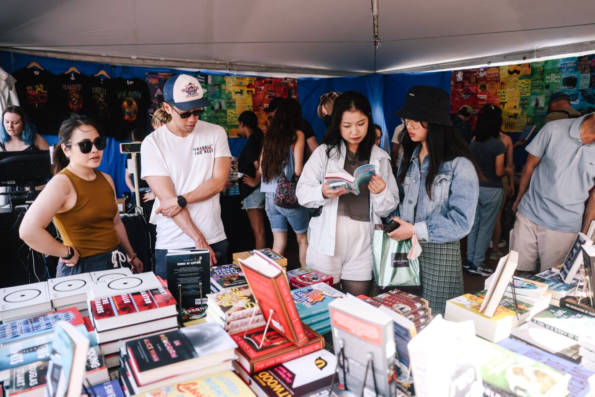 People check a book board during the Los Angeles Times Book Festival.