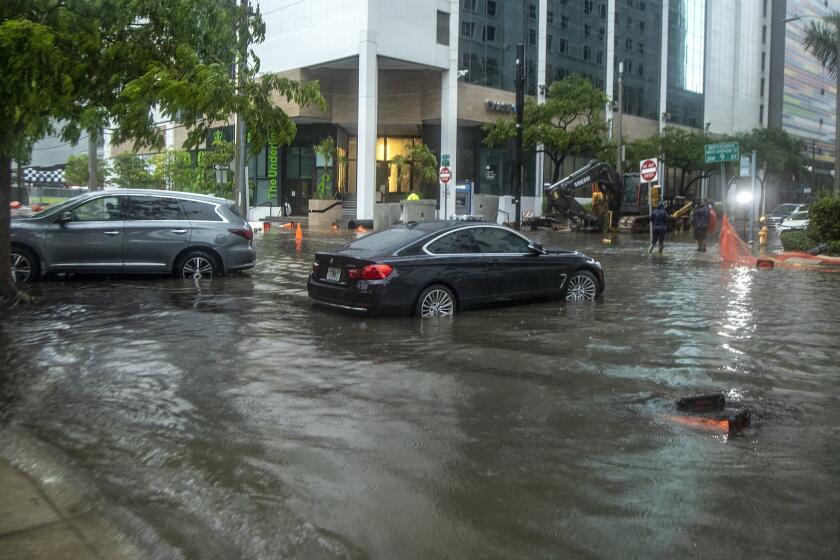 Rainfall from Tropical Storm Alex floods the Brickell area near downtown Miami, Saturday June 4, 2022. (Pedro Portal/Miami Herald via AP)