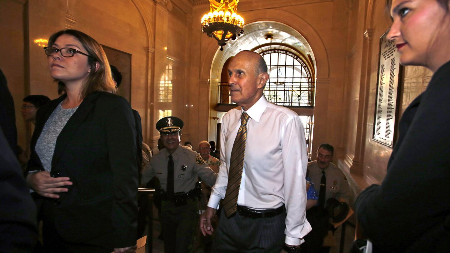 Former Los Angeles County Sheriff Lee Baca walks up the main staircase for his first look at the refurbished Hall of Justice.