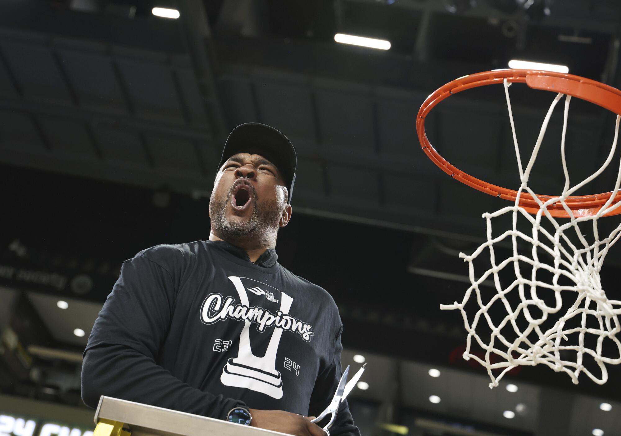 Senque Carey cheers while cutting the net.