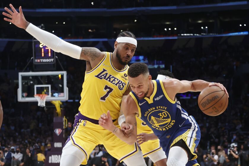Golden State Warriors guard Stephen Curry (30) drives against Los Angeles Lakers forward Carmelo Anthony (7) during the second half of an NBA basketball game in Los Angeles, Tuesday, Oct. 19, 2021. The Warriors won 121-114. (AP Photo/Ringo H.W. Chiu)
