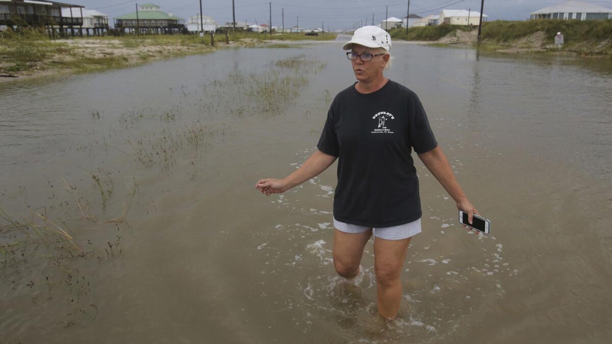 Susan Jones walks through a flooded road Sept. 5 in Dauphin Island, Ala., after Tropical Storm Gordon came ashore.