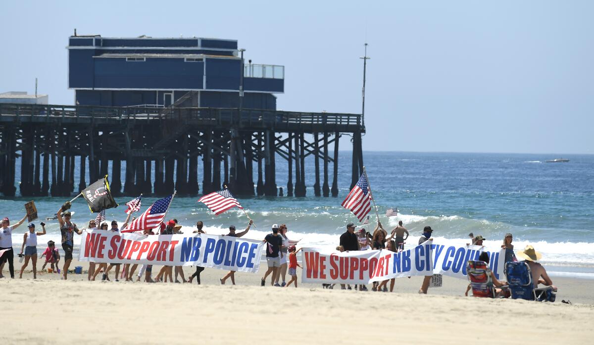 Protesters rally against beach closures in Newport Beach
