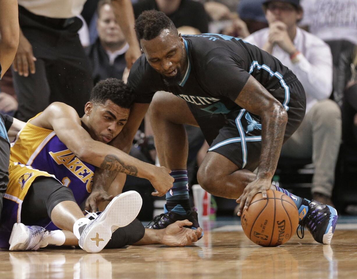 Hornets forward P.J. Hairston, right, steals the ball from Lakers guard D'Angelo Russell, left, in the first half.