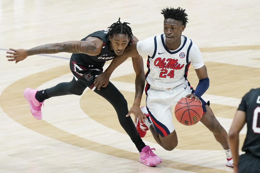 Mississippi's Jarkel Joiner (24) moves past South Carolina's T.J. Moss in the first half of an NCAA college basketball game in the Southeastern Conference Tournament Thursday, March 11, 2021, in Nashville, Tenn. (AP Photo/Mark Humphrey)