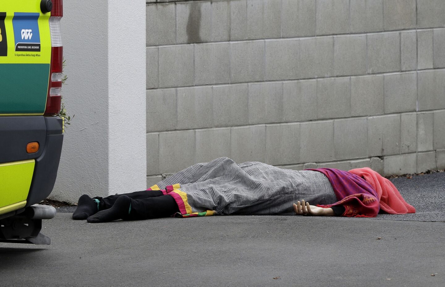 A body lies on a sidewalk outside a mosque in central Christchurch.