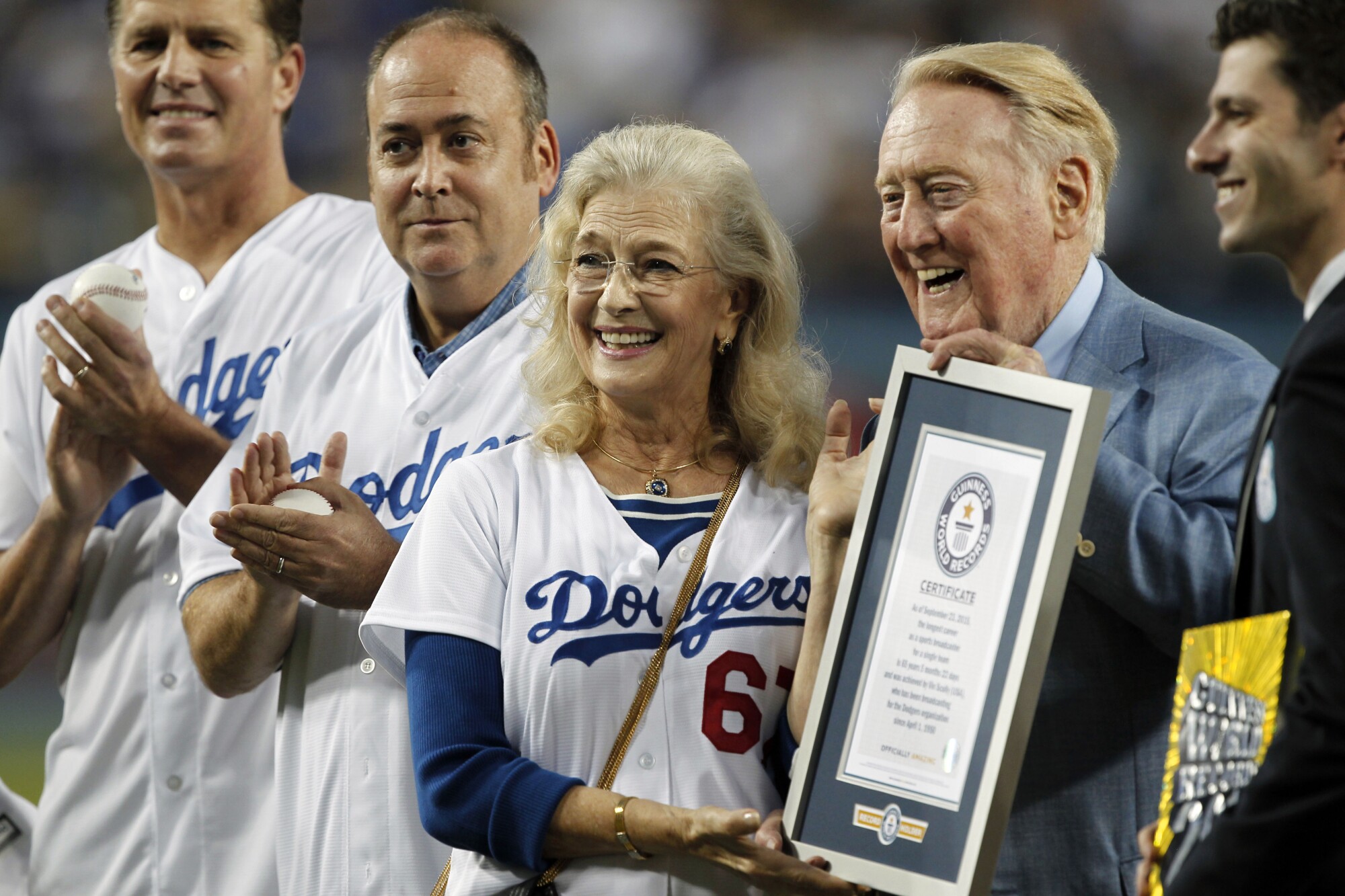 Vin Scully is presented a Guinness World Records certificate for the longest career as a sports broadcaster for a single team