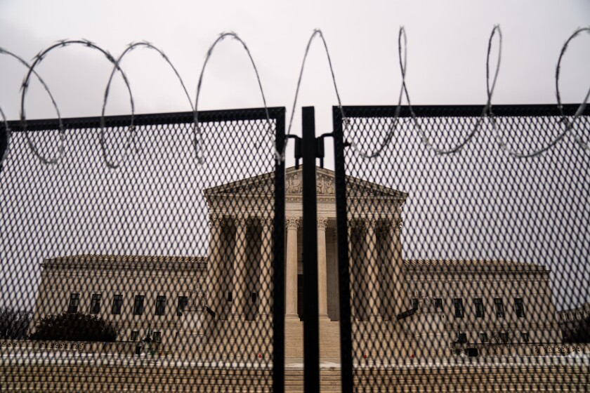 Razor wire topped fencing surrounds the Supreme Court building. 