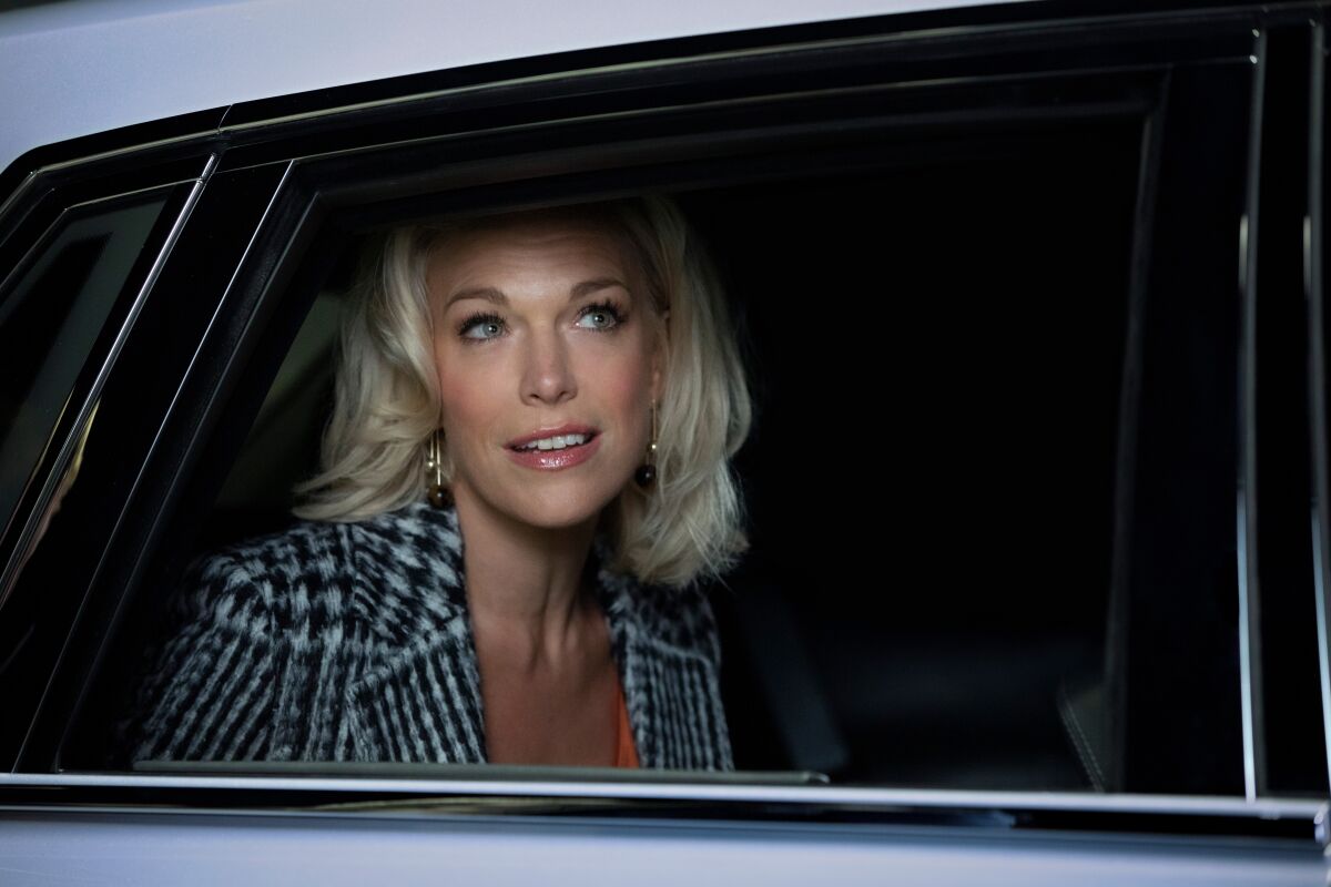 Actress Hannah Waddingham peers out a car window in a scene from the Apple TV+ comedy "Ted Lasso."