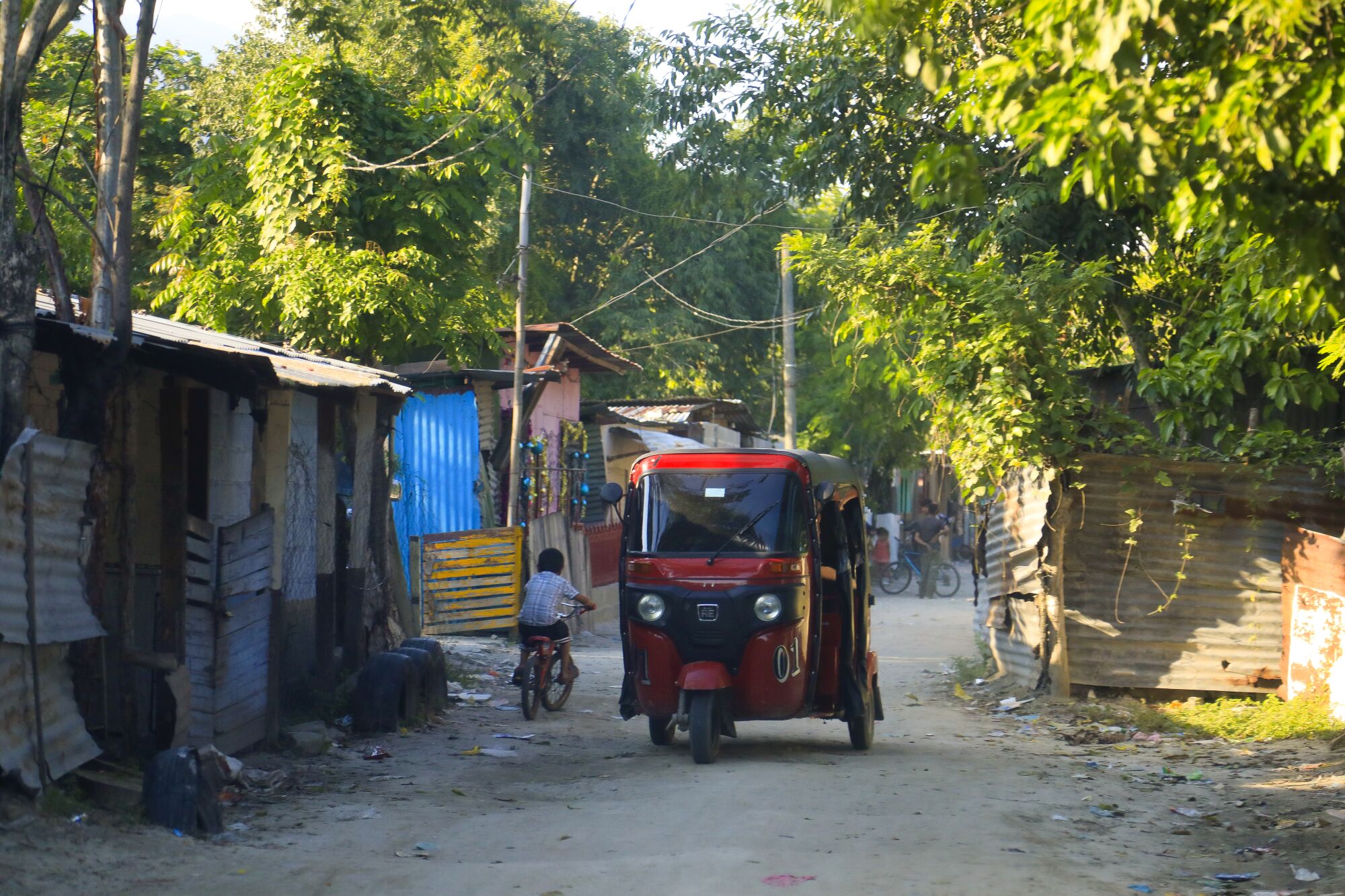 A mototaxi passes through a neighborhood in Honduras