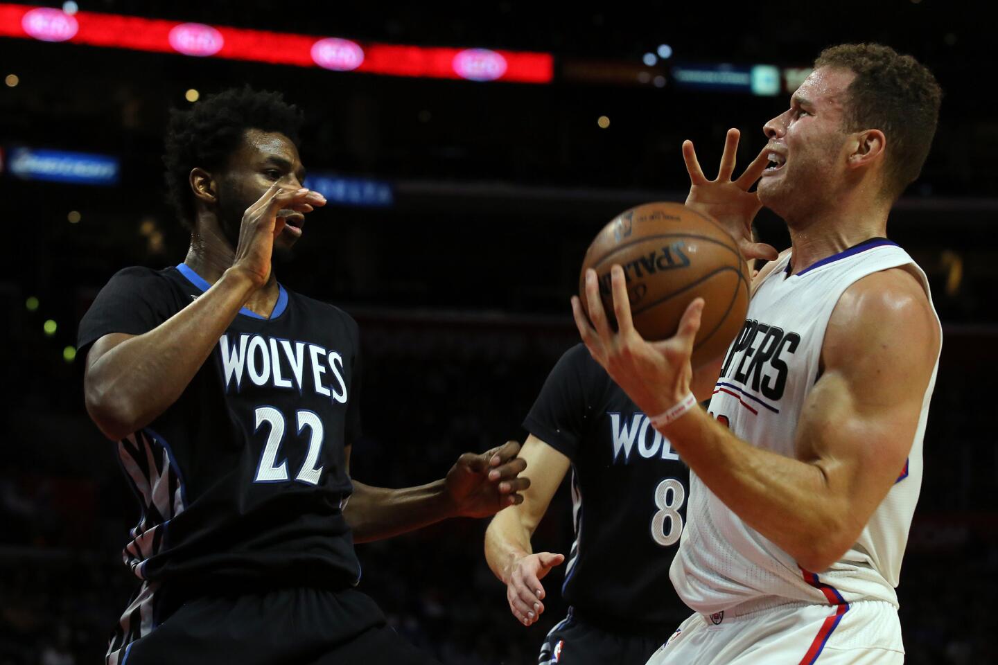 Clippers forward Blake Griffin grabs a loose ball in front of Timberwolves forward Andrew Wiggins in the first half Sunday.
