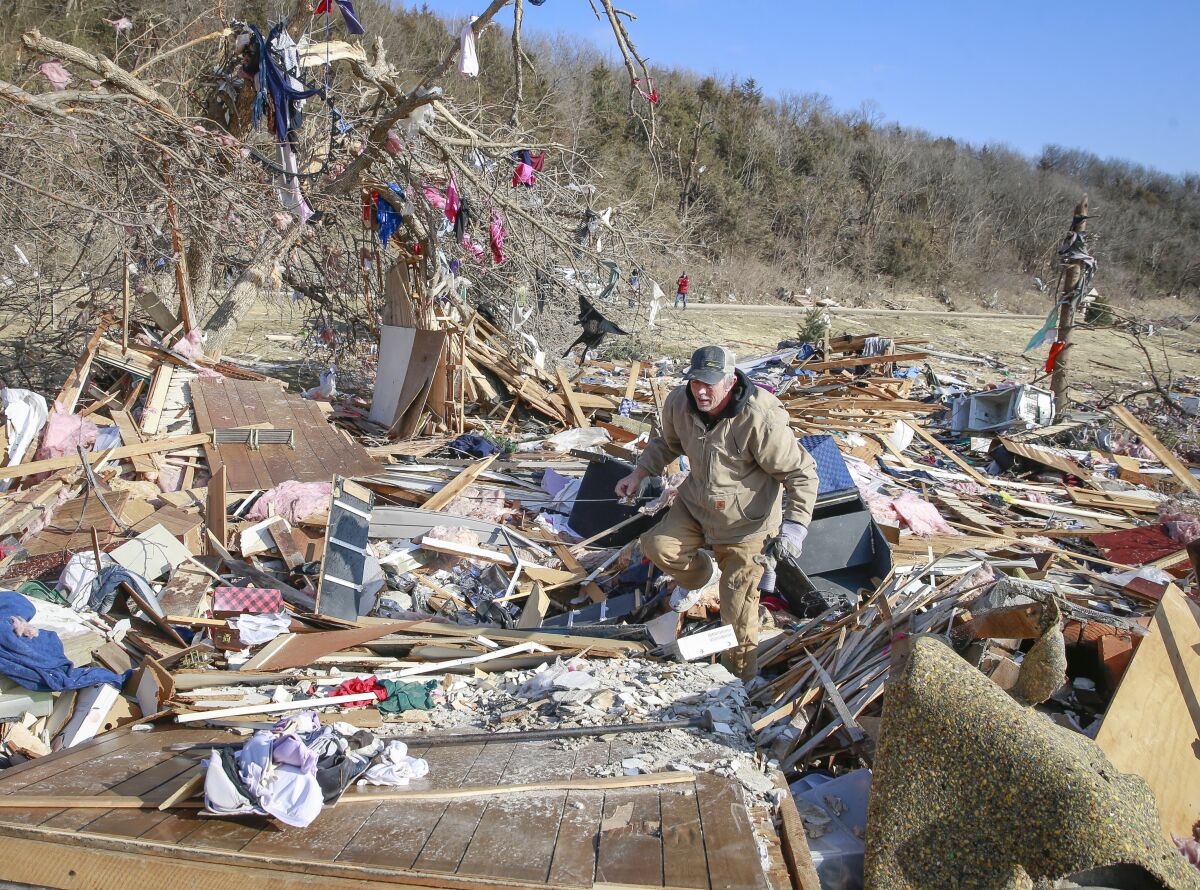 Cleanup efforts are underway in Winterset, Iowa, on Sunday, March 6, 2022, after a tornado tore through an area southwest of town on Saturday. (Bryon Houlgrave/The Des Moines Register via AP)