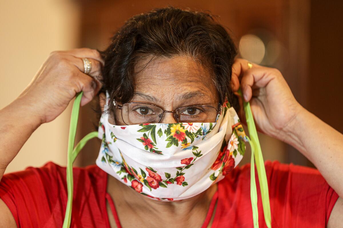 Bibi Sheonarine of Upland models a face mask that she sewed. She has sewn a number of masks to donate to local doctors and hospitals, and has recruited others to do the same.