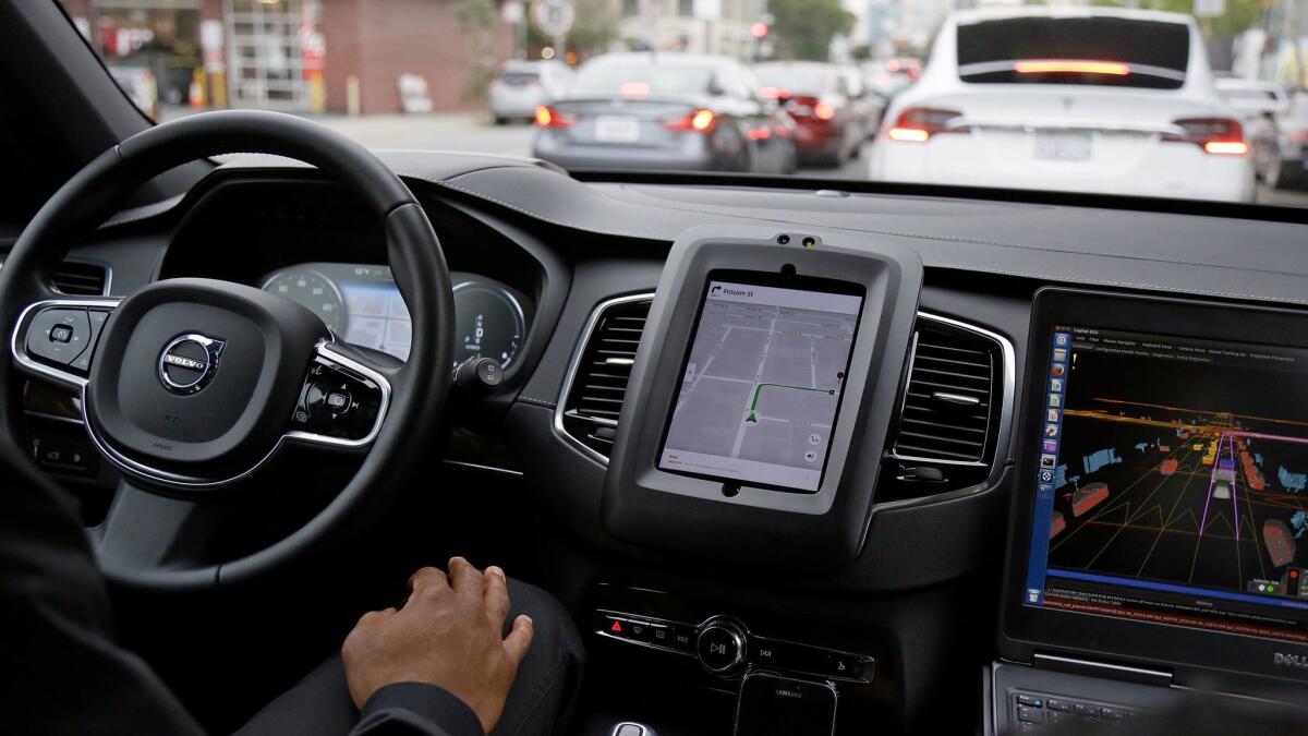 A Volvo equipped with self-driving technology inches through traffic in San Francisco.