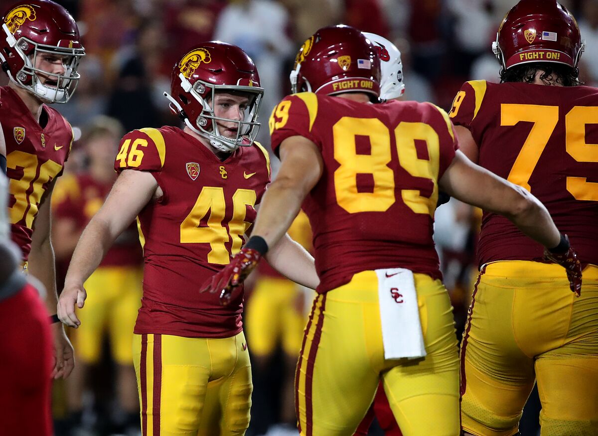 USC kicker Denis Lynch is congratulated by teammates after a field goal against Fresno State.