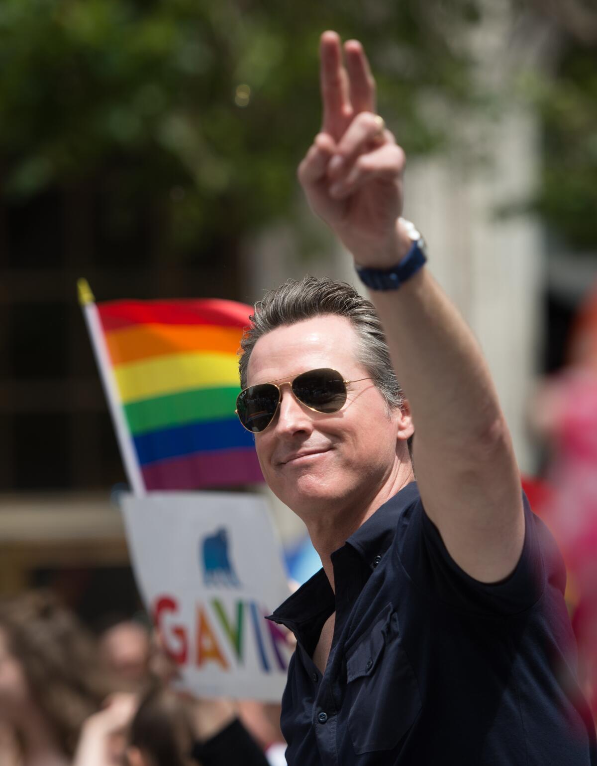 Gavin Newsom waves to a crowd during the San Francisco Pride parade in 2017.
