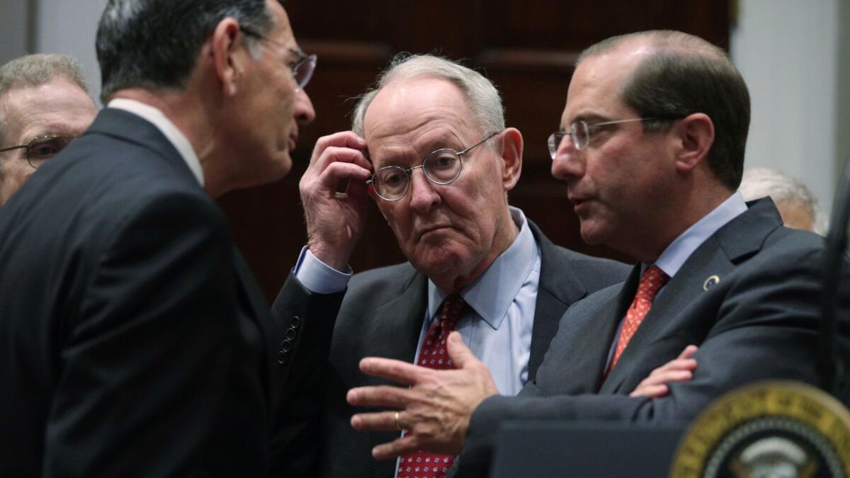 Sen. Lamar Alexander (R-Tenn.), center, confers at the White House on May 9 on surprise billing legislation before his Senate Health Committee, flanked by Sen. John Barrasso (R-Wyo.), left, and Health and Human Services Secretary Alex Azar.