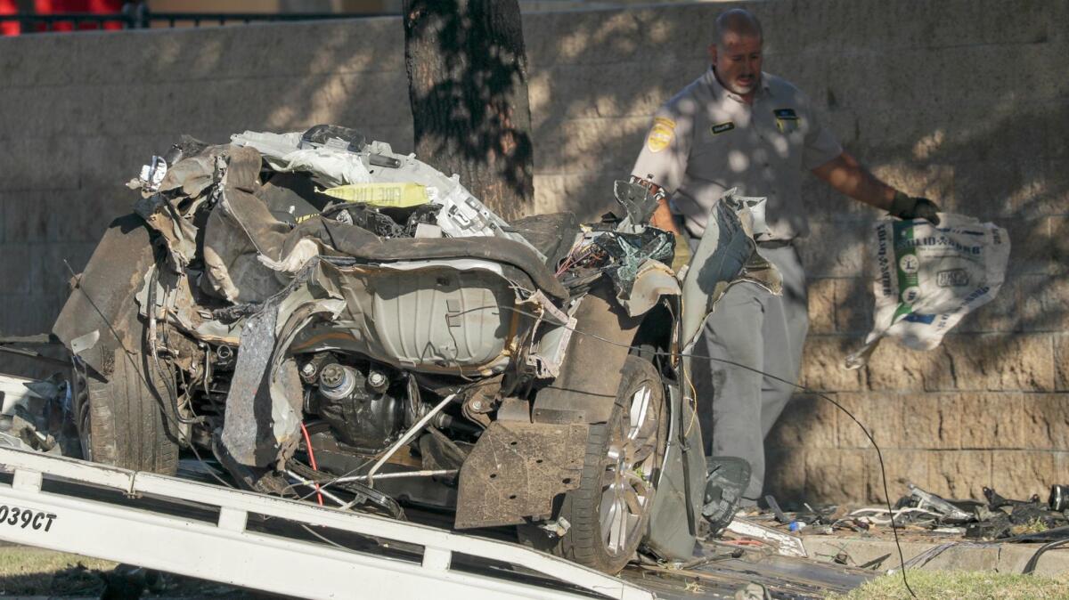 A silver BMW broke into pieces after hitting a utility pole and striking a tree at high speed in Northridge late Friday, killing all four people inside.