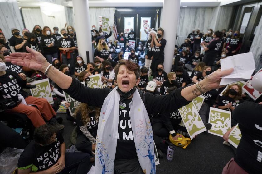Demonstrators stage a sit-in demanding a cease-fire in the Israel-Hamas war Monday, Nov. 13, 2023, in Oakland, Calif. (AP Photo/Godofredo A. Vásquez)