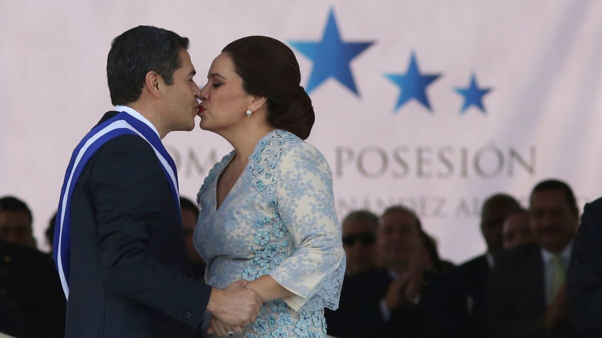 Honduran President Juan Orlando Hernandez kisses his wife Ana Garcia after being sworn in for a second term.