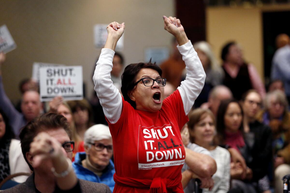 A woman reacts at a meeting on Aliso Canyon held by state regulators.