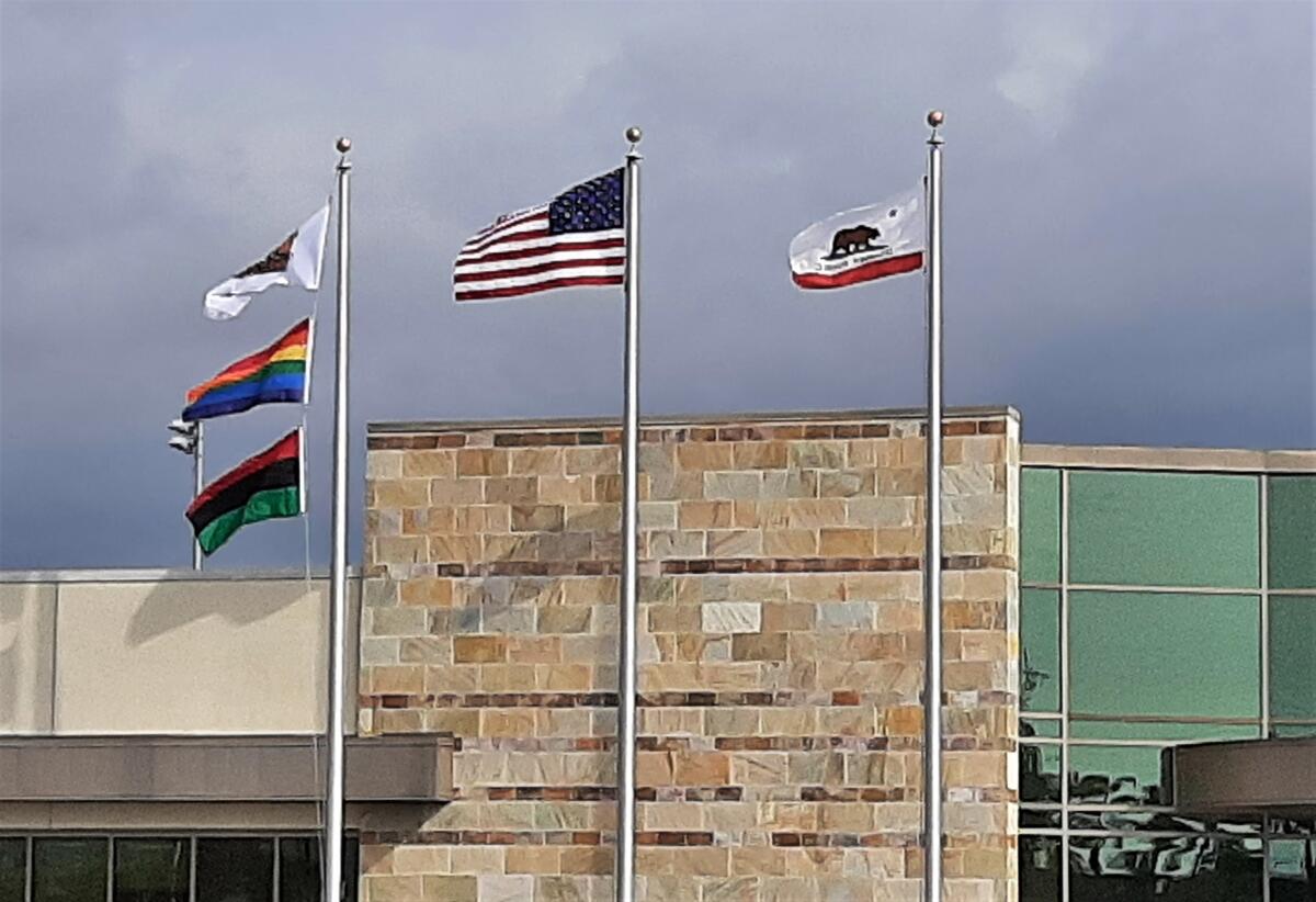 A Pan African flag, bottom left, is shown flying at the OC Fair & Event Center in recognition of 2022 Black History Month.