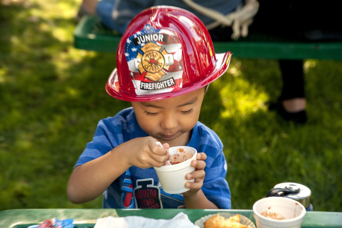 A young attendee samples some chili during the 2017 Halecrest Park chili cook-off.