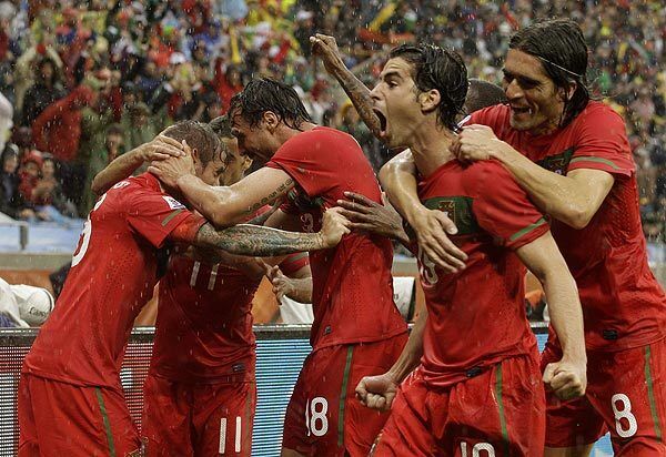Portugal's Raul Meireles, left, celebrates with teammates after scoring a goal during a World Cup Group G match against North Korea in Cape Town, South Africa, on Monday.
