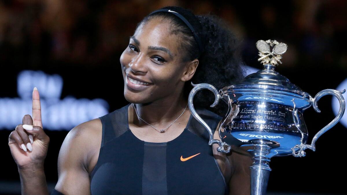 Serena Williams holds up a finger and her trophy after defeating her sister, Venus, in the women's singles final at the Australian Open tennis championships in Melbourne, Australia on Jan. 28.