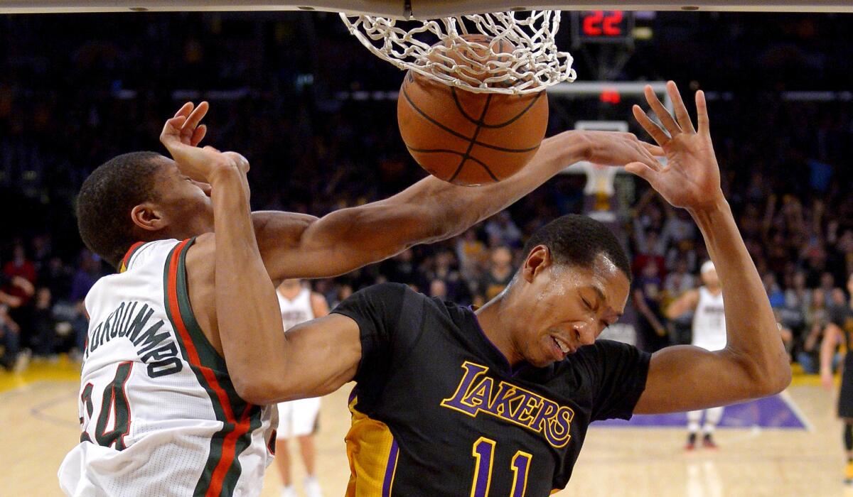 Lakers forward Wesley Johnson dunks against Bucks forward Giannis Antetokounmpo in the second half Friday night at Staples Center.