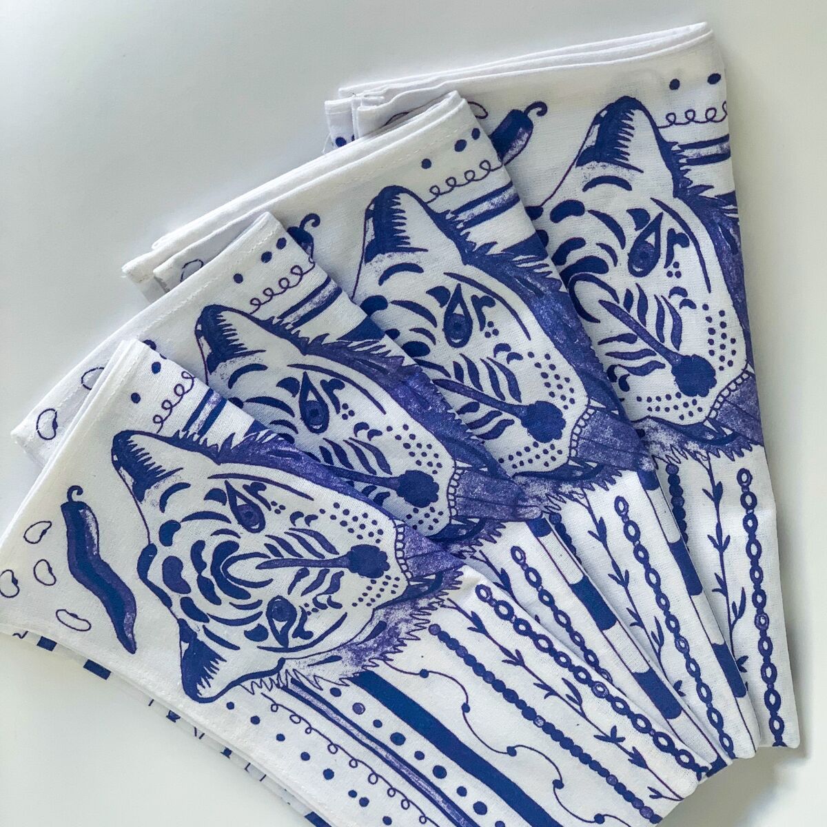 Blue and white table napkins bearing a tiger design