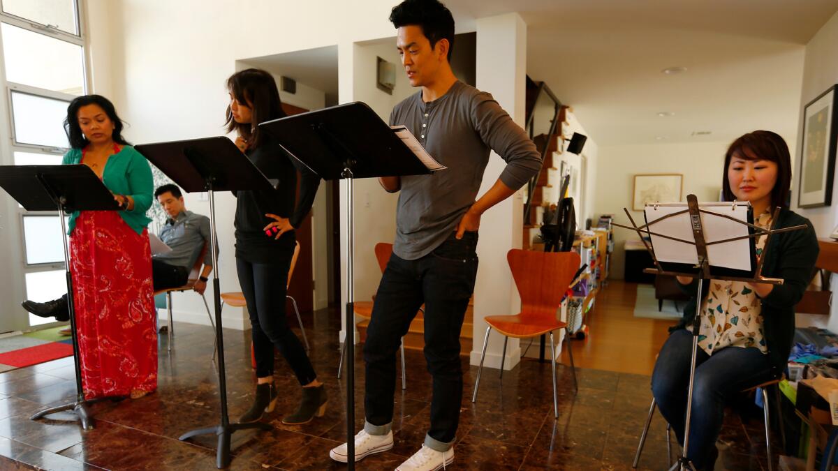 Melody Butiu, left, Reggie Lee (sitting), Kerri Higuchi, John Cho and Julia Cho rehearse Donald Margulies' "Dinner With Friends" on Thursday in advance of Artists at Play's staged reading this weekend.