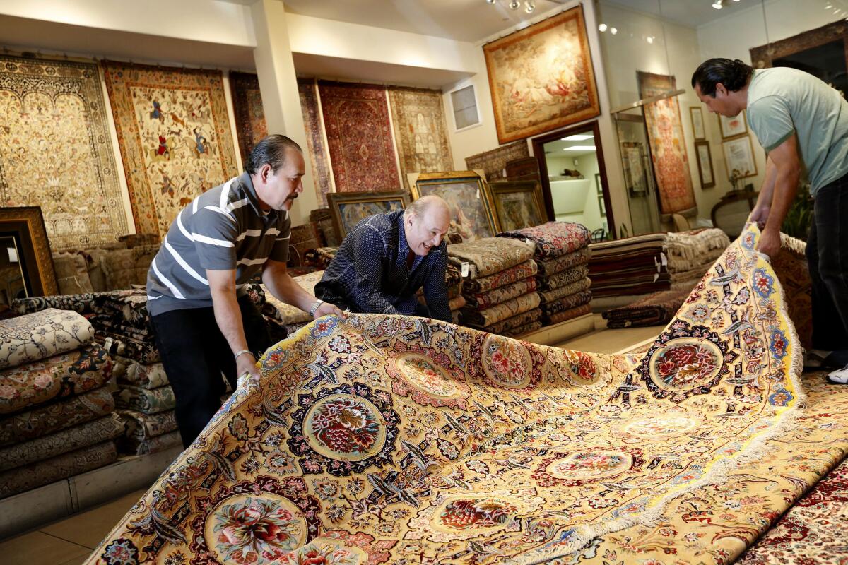 Alex Helmi, owner of Damoka, receives his first shipment of rugs from Iran. The nuclear deal allows shipments to come to the U.S. once again.