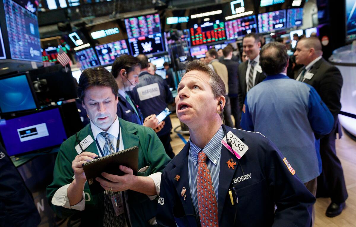 Traders work at the opening bell on the floor of the New York Stock Exchange in New York. World financial markets are reacting to the escalating threat of a widespread outbreak of the coronavirus, which has killed at least 80 people in China and infected thousands of others.