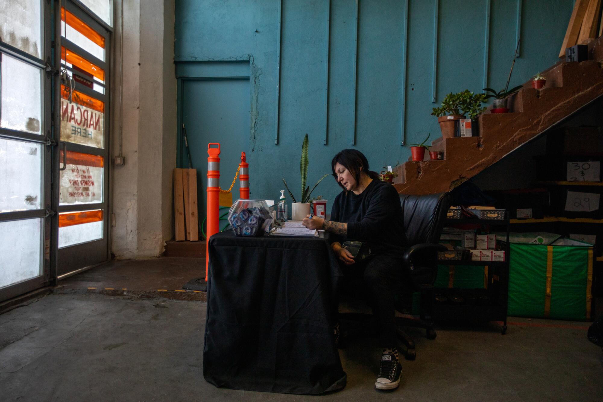 A woman sits at a table 