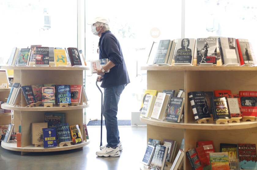 A customer browses the shelves at a bookstore