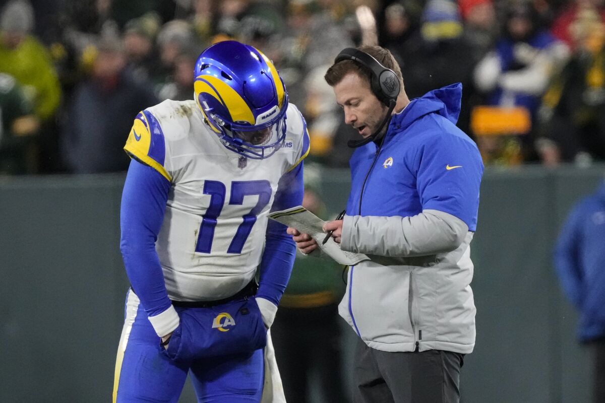 Quarterback Baker Mayfield (17) confers with Rams coach Sean McVay.